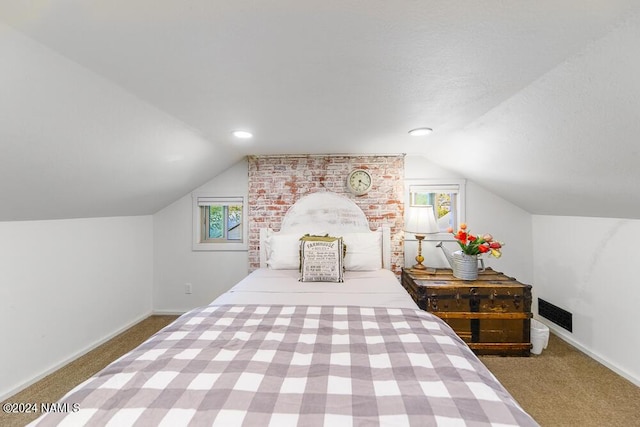 carpeted bedroom with vaulted ceiling