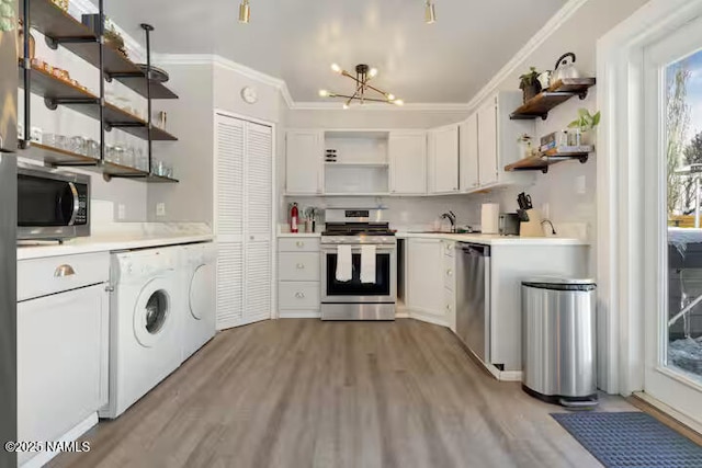 420 W Navajo Rd, Flagstaff, AZ 86001 - kitchen featuring open shelves, appliances with stainless steel finishes, separate washer and dryer, light countertops, and crown molding