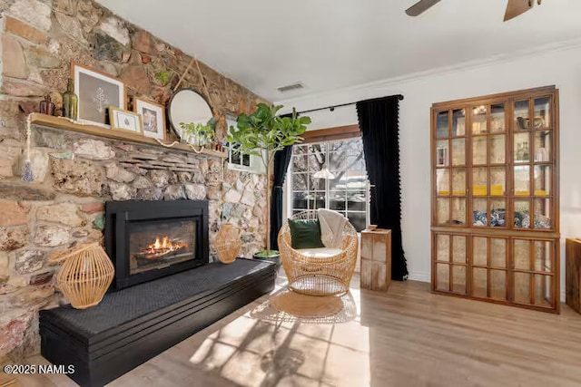 420 W Navajo Rd, Flagstaff, AZ 86001 - sitting room featuring a fireplace, ceiling fan, wood finished floors, ornamental molding, and baseboards
