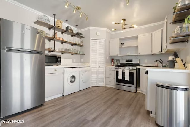 420 W Navajo Rd, Flagstaff, AZ 86001 - kitchen with open shelves, appliances with stainless steel finishes, light countertops, separate washer and dryer, and a chandelier