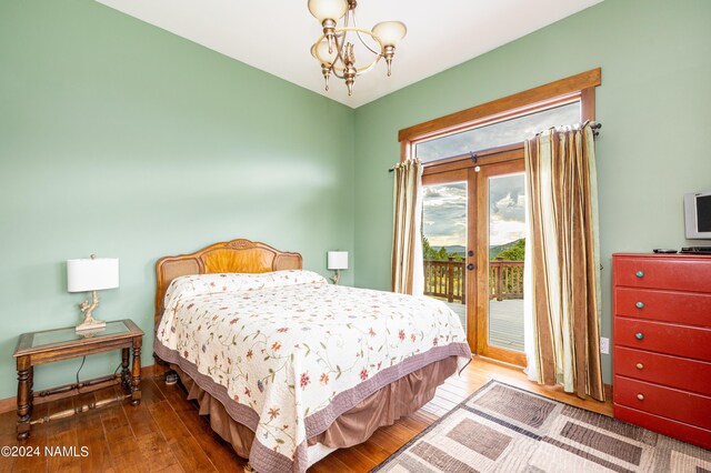 bedroom with access to exterior, a chandelier, french doors, and hardwood / wood-style floors