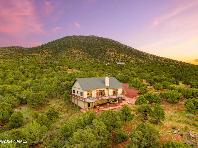 aerial view at dusk featuring a mountain view