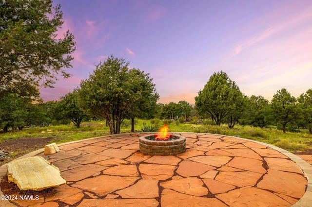 patio terrace at dusk with an outdoor fire pit