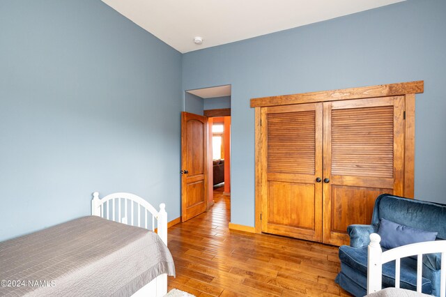 bedroom featuring a closet and light hardwood / wood-style flooring