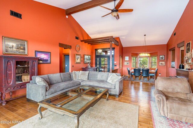 living room featuring light hardwood / wood-style floors, ceiling fan, high vaulted ceiling, and beamed ceiling