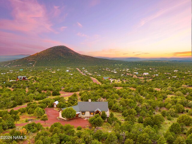 aerial view at dusk featuring a mountain view