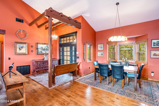 dining space with hardwood / wood-style flooring, high vaulted ceiling, french doors, and beam ceiling