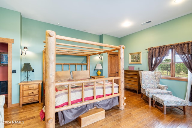 bedroom with hardwood / wood-style flooring