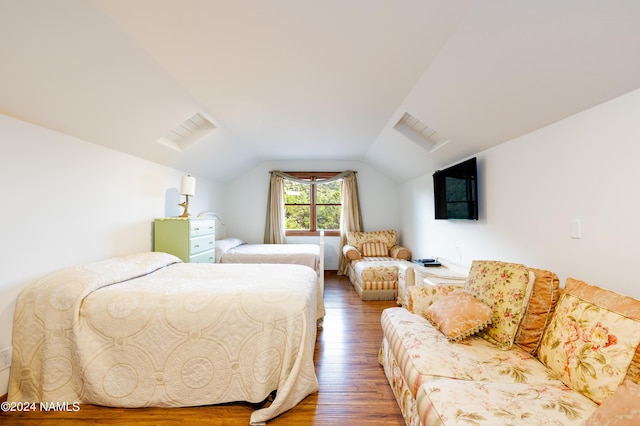 bedroom with wood-type flooring and lofted ceiling