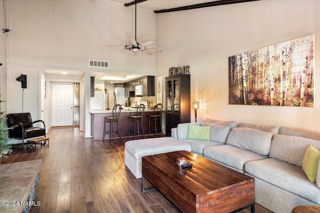 living room featuring beamed ceiling, ceiling fan, dark hardwood / wood-style floors, and high vaulted ceiling