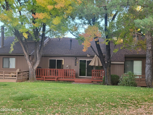 back of property featuring a yard and a deck