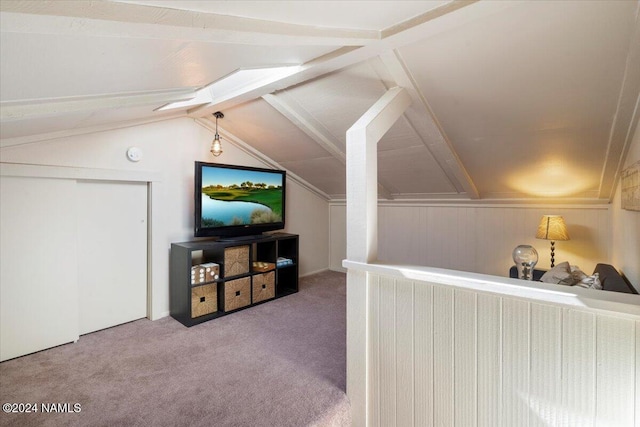 bonus room with lofted ceiling with beams and carpet floors