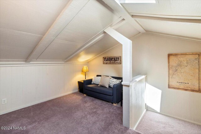 interior space with lofted ceiling with beams and carpet floors