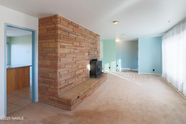 unfurnished living room featuring a wood stove