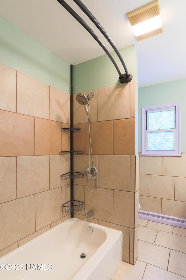 bathroom featuring tile patterned floors, toilet, and tiled shower / bath