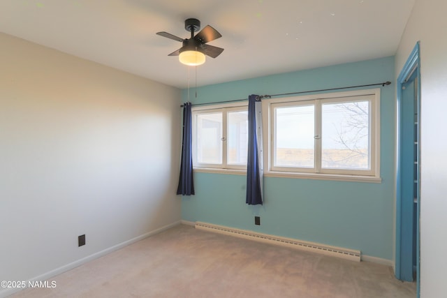 unfurnished room with light carpet, ceiling fan, and a baseboard heating unit