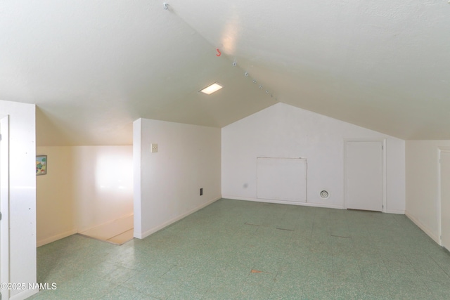 additional living space featuring lofted ceiling