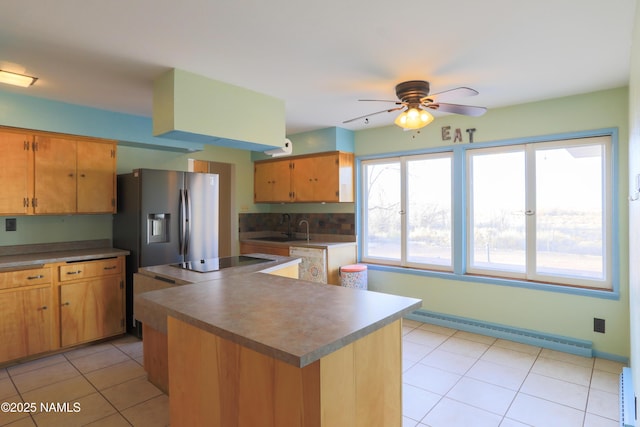 kitchen with a center island, stainless steel fridge with ice dispenser, baseboard heating, black electric cooktop, and sink