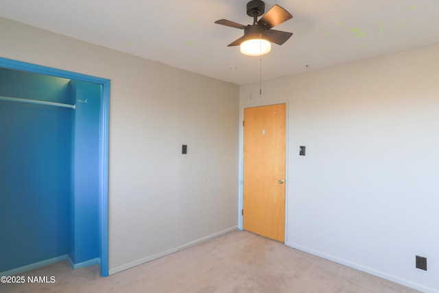 unfurnished bedroom featuring a closet, ceiling fan, and light carpet