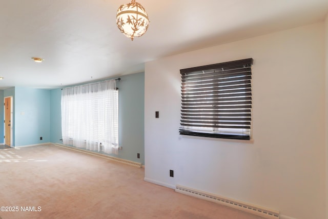 unfurnished room featuring light carpet and baseboard heating