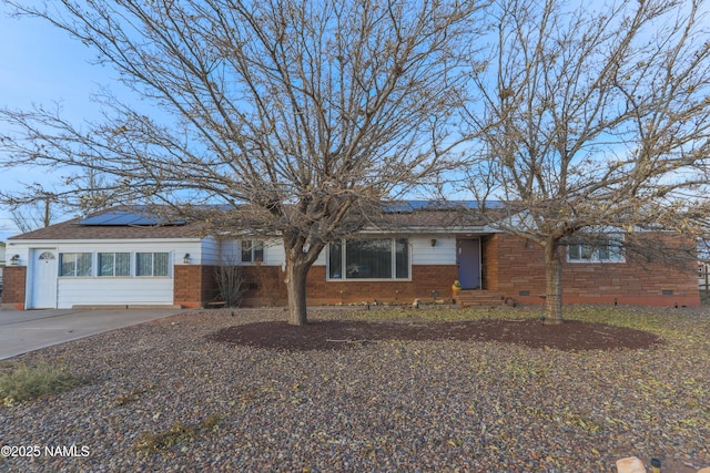 ranch-style home featuring solar panels