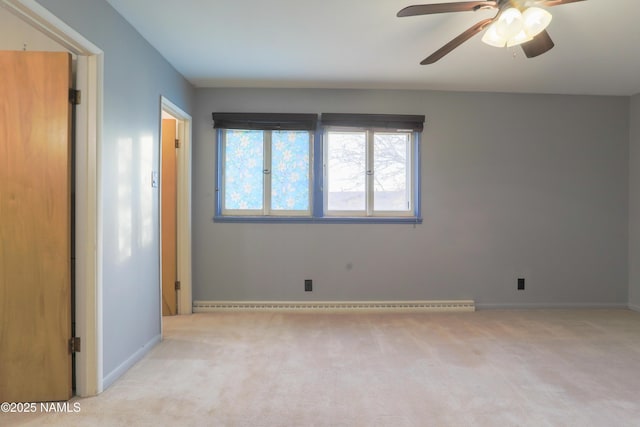 unfurnished room with ceiling fan, a baseboard heating unit, and light carpet