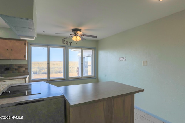 kitchen with light tile patterned floors and ceiling fan