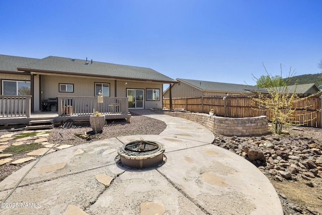905 Hereford Dr, Williams, AZ 86046 - rear view of property with a fenced backyard, a patio, a fire pit, a deck, and a shingled roof