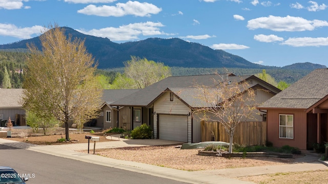 905 Hereford Dr, Williams, AZ 86046 - view of front facade with a mountain view, fence, a garage, and driveway