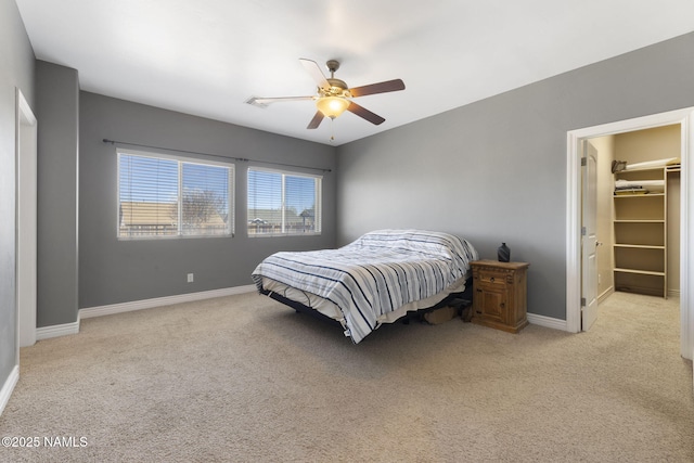 905 Hereford Dr, Williams, AZ 86046 - bedroom featuring light carpet, baseboards, a spacious closet, and a ceiling fan