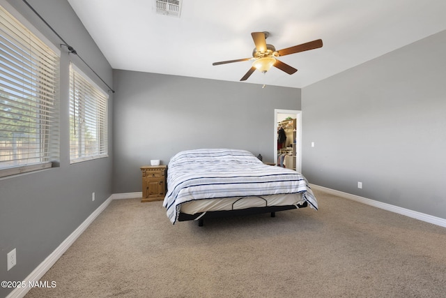 905 Hereford Dr, Williams, AZ 86046 - bedroom with light colored carpet, a walk in closet, and baseboards