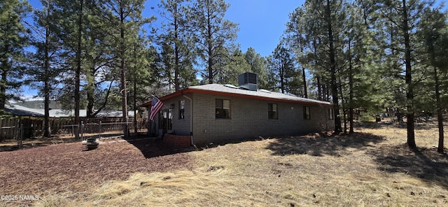 1111 W Sheridan Ave, Williams, AZ 86046 - view of home's exterior with a chimney and brick siding
