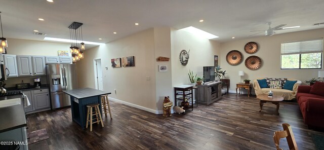 1111 W Sheridan Ave, Williams, AZ 86046 - kitchen with appliances with stainless steel finishes, open floor plan, dark wood-style floors, a ceiling fan, and dark countertops