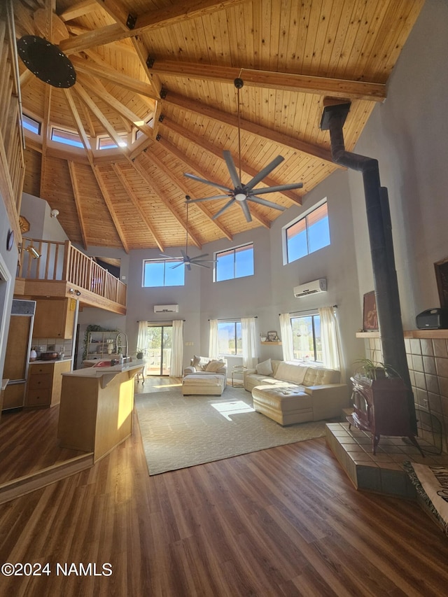 living room with wood ceiling, a wood stove, a high ceiling, beam ceiling, and dark hardwood / wood-style flooring