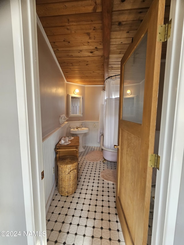 bathroom featuring wood ceiling, wood walls, crown molding, and vanity