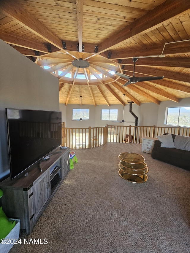 unfurnished living room with carpet floors, vaulted ceiling with beams, ceiling fan, and wood ceiling