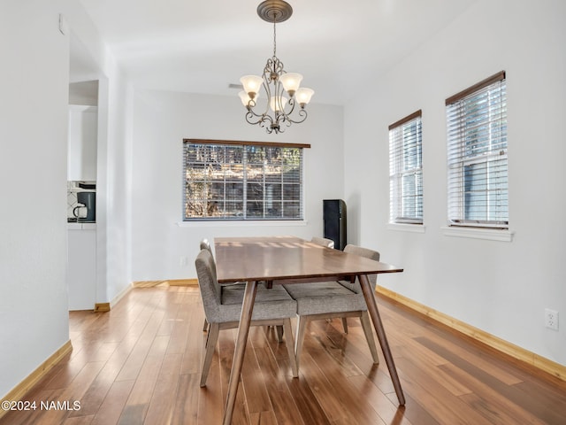 dining room with a chandelier and hardwood / wood-style floors