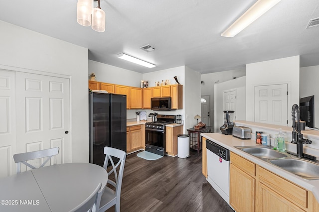 9092 W Slate Mountain Trl, Bellemont, AZ 86015 - kitchen with freestanding refrigerator, gas range, black microwave, white dishwasher, and a sink