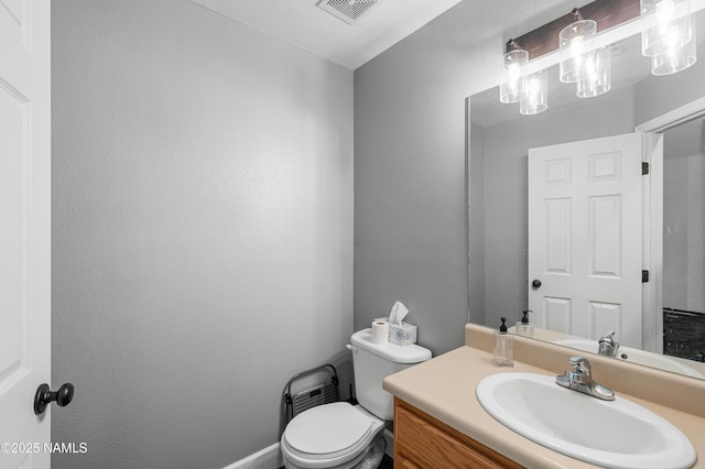 9092 W Slate Mountain Trl, Bellemont, AZ 86015 - bathroom featuring toilet, vanity, and a textured wall