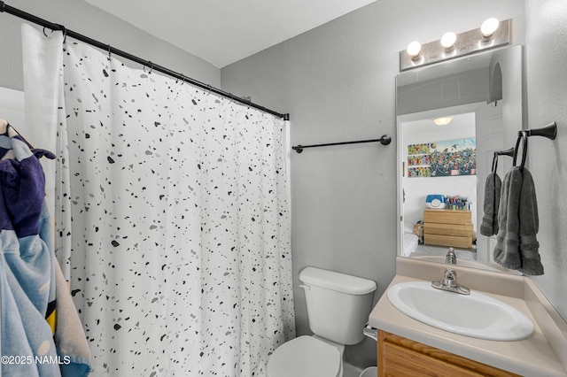 9092 W Slate Mountain Trl, Bellemont, AZ 86015 - bathroom with toilet, vanity, and curtained shower