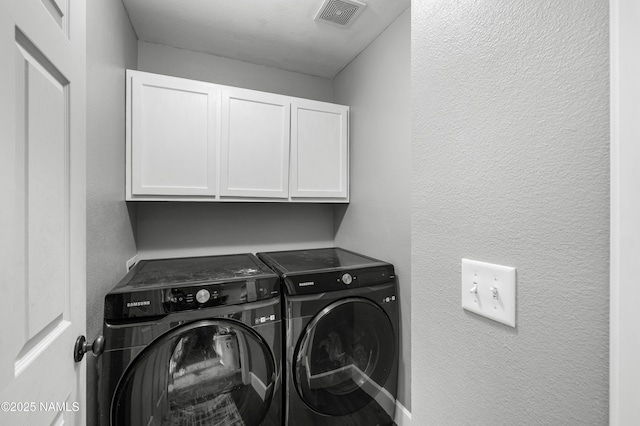 9092 W Slate Mountain Trl, Bellemont, AZ 86015 - laundry room featuring cabinet space, washer and dryer, and a textured wall