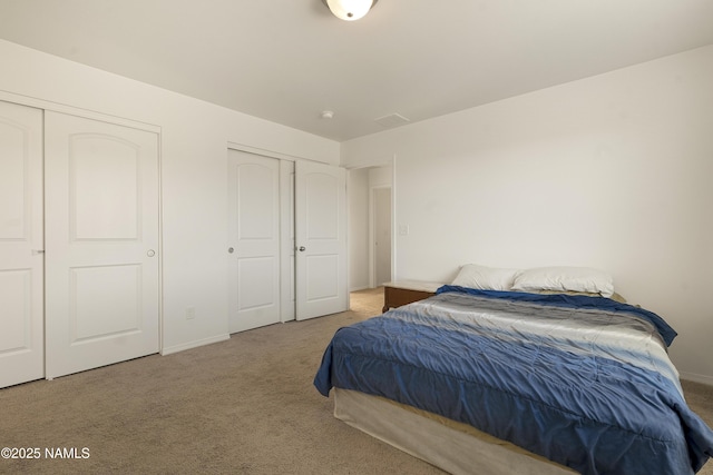 12361 Pegasus Rd, Bellemont, AZ 86015 - carpeted bedroom featuring multiple closets and baseboards