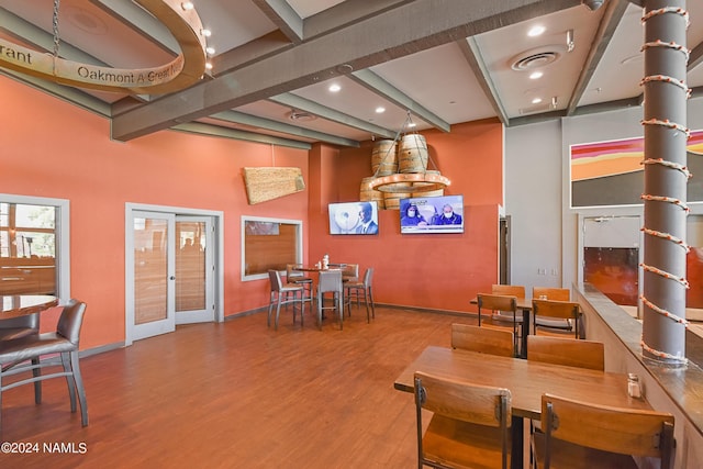 dining area with hardwood / wood-style flooring, beamed ceiling, and french doors