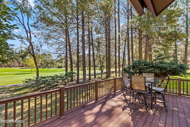 wooden terrace with a yard