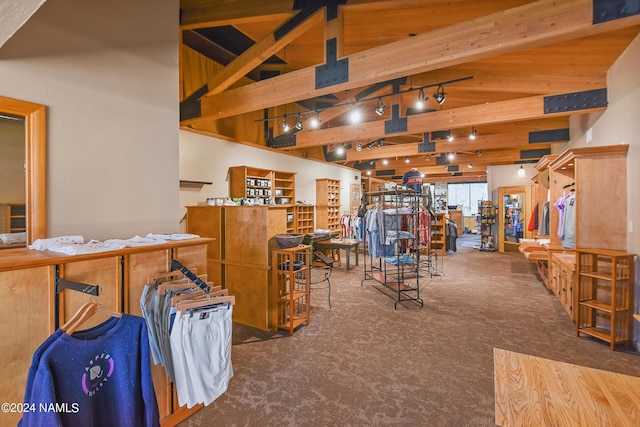 misc room with beamed ceiling, high vaulted ceiling, and dark carpet