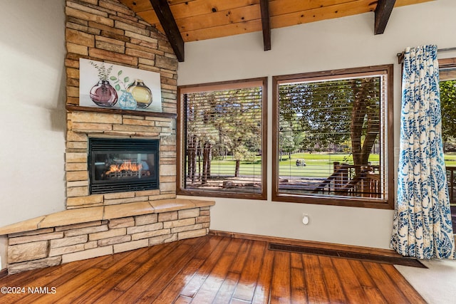 unfurnished living room featuring a fireplace, hardwood / wood-style floors, lofted ceiling with beams, and wooden ceiling