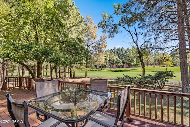 wooden deck featuring a yard