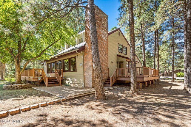 back of house featuring a deck