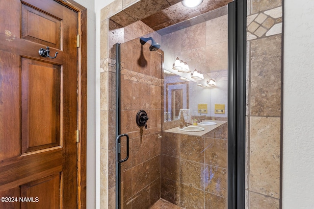 bathroom featuring dual sinks and walk in shower