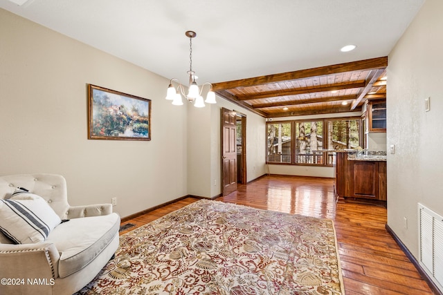 interior space featuring beam ceiling, a chandelier, light hardwood / wood-style flooring, and wooden ceiling